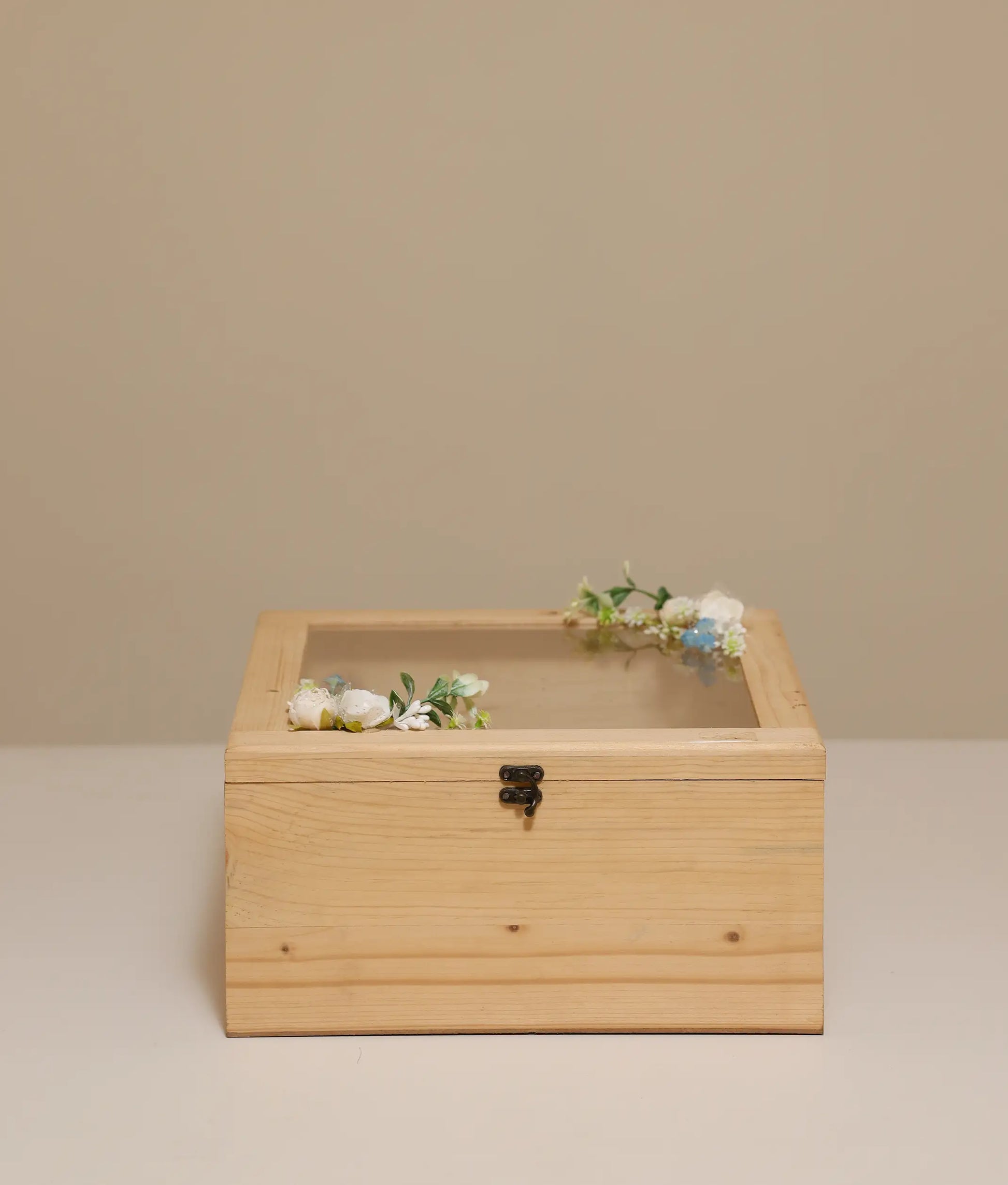 Off-white decorative flower wicker baptism basket against plain background