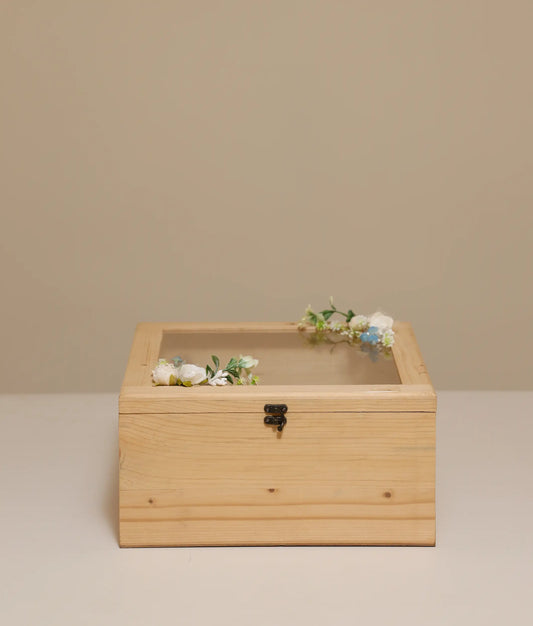 Off-white decorative flower wicker baptism basket against plain background