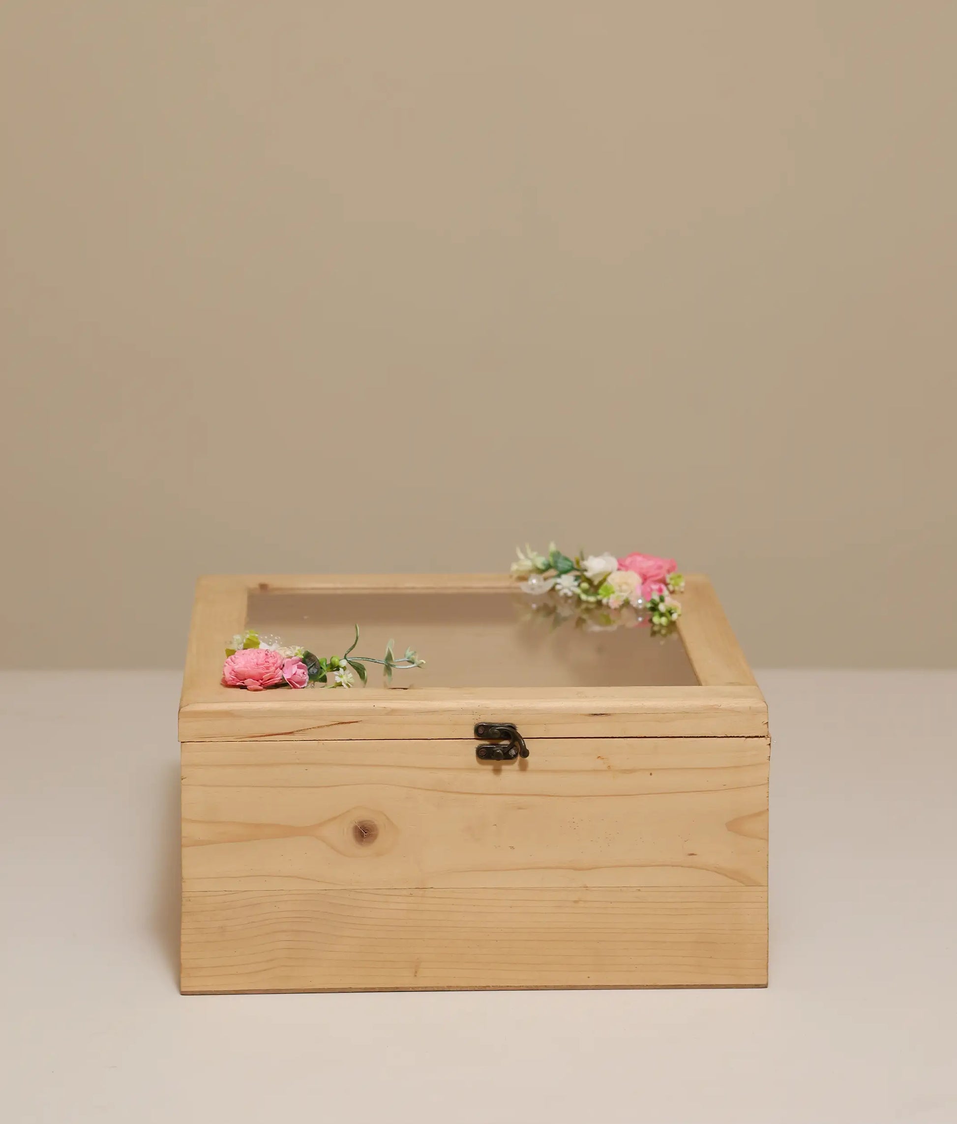 Pink and off-white decorative flower baptism wooden box against plain background