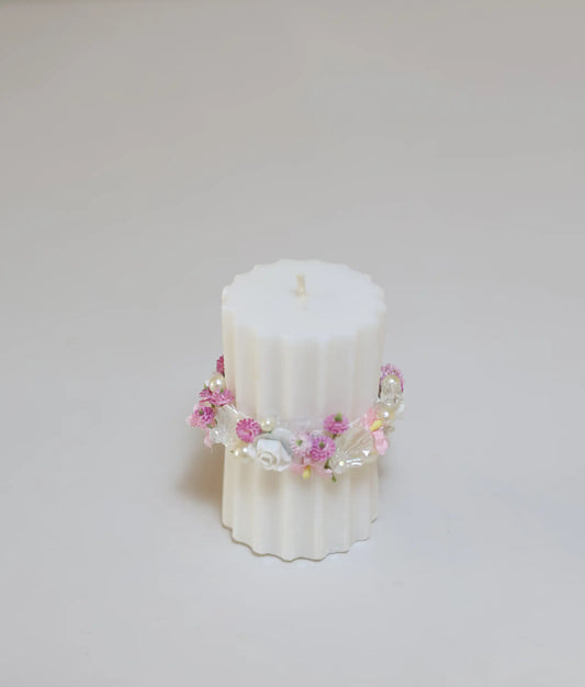 Close view of off-white and pink floral flower pillar candle for your baby baptism