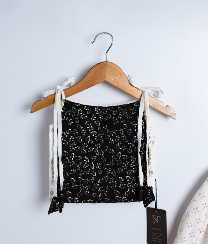 Close view of an black georgette crop top displayed on hangers against a white background.