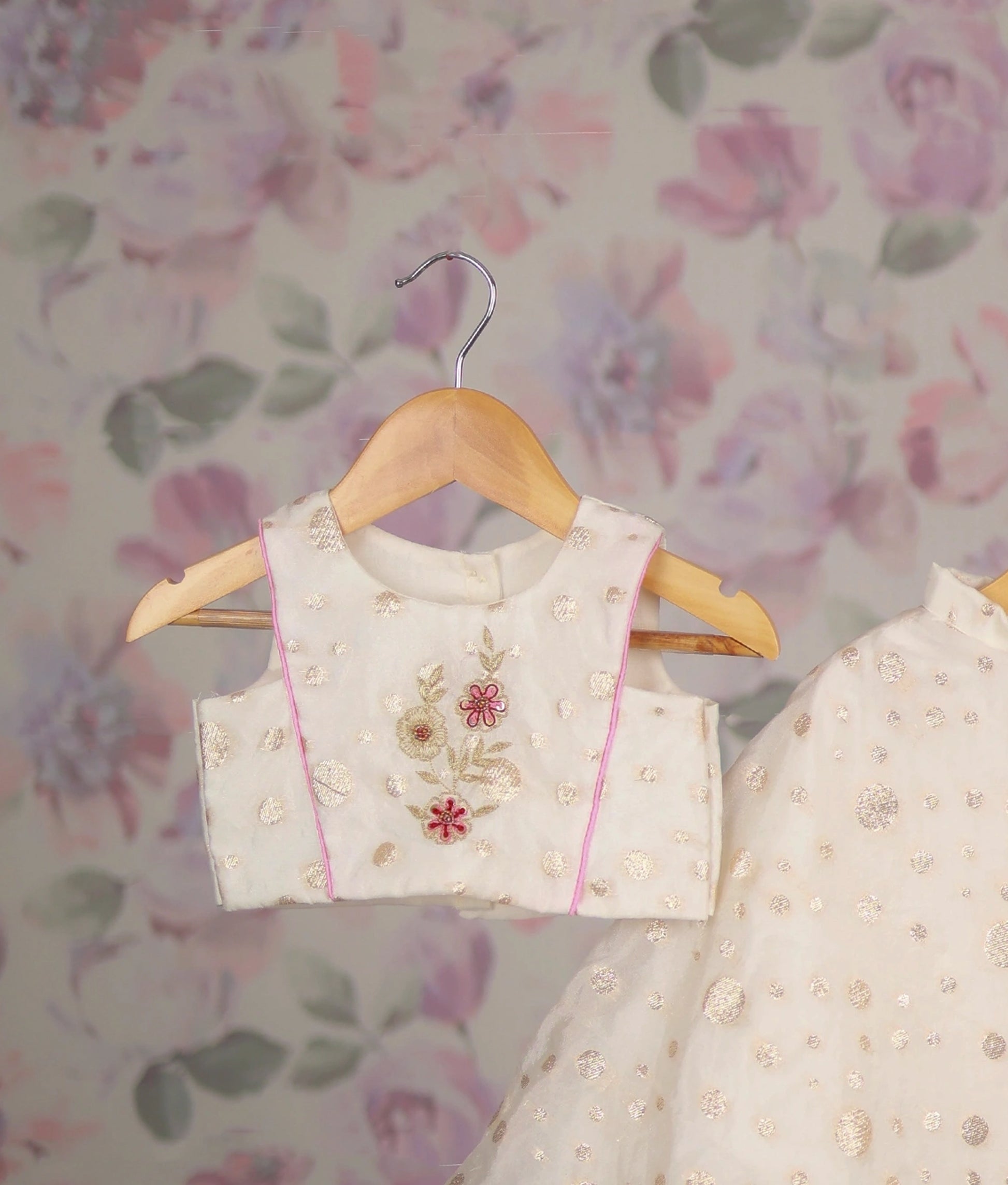 Close view of an off-white baby girl lehenga choli with floral embroidery, perfect ethnic wear for kids."