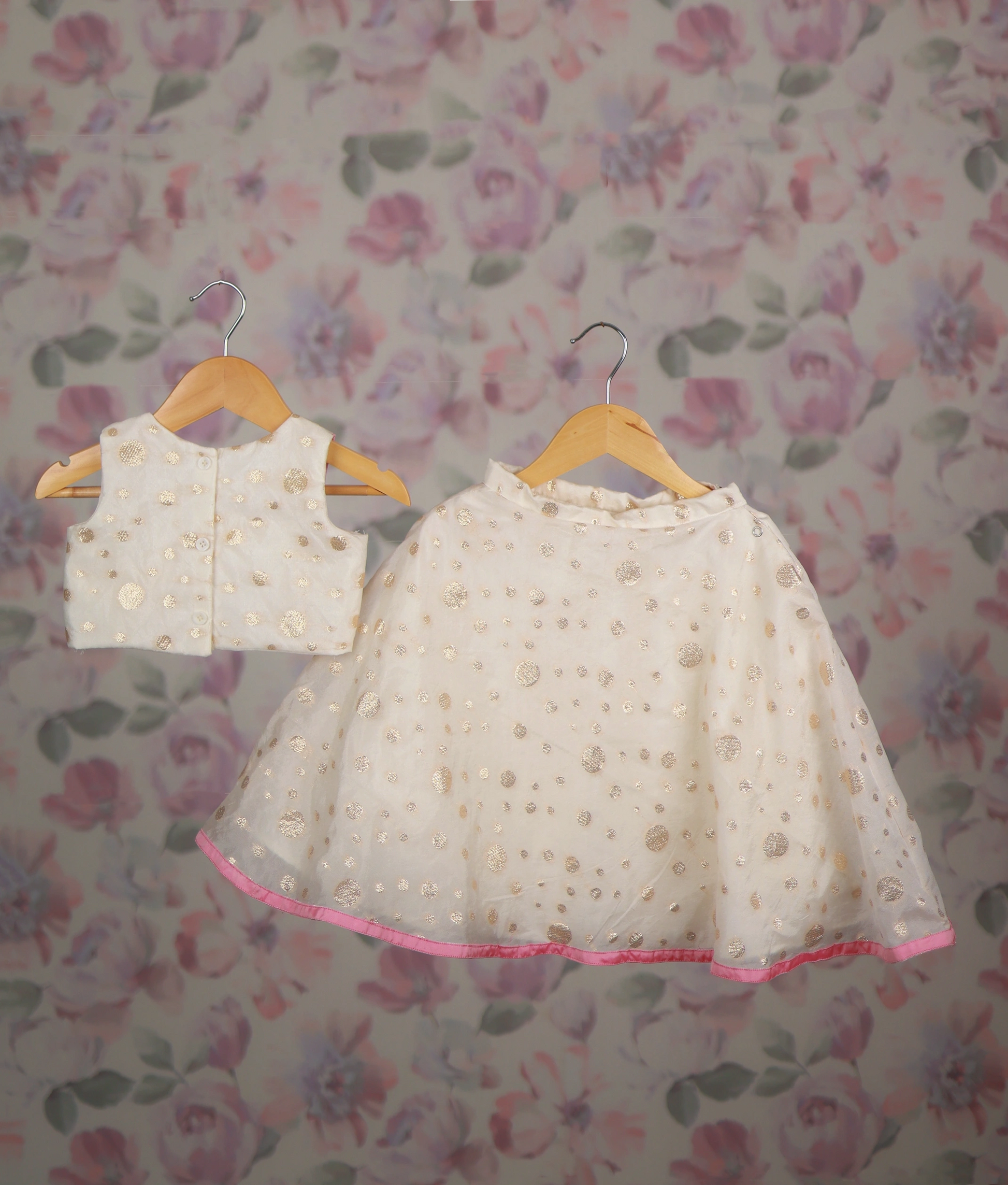 Back view of an off-white baby girl's lehenga choli with floral embroidery, perfect ethnic wear for kids