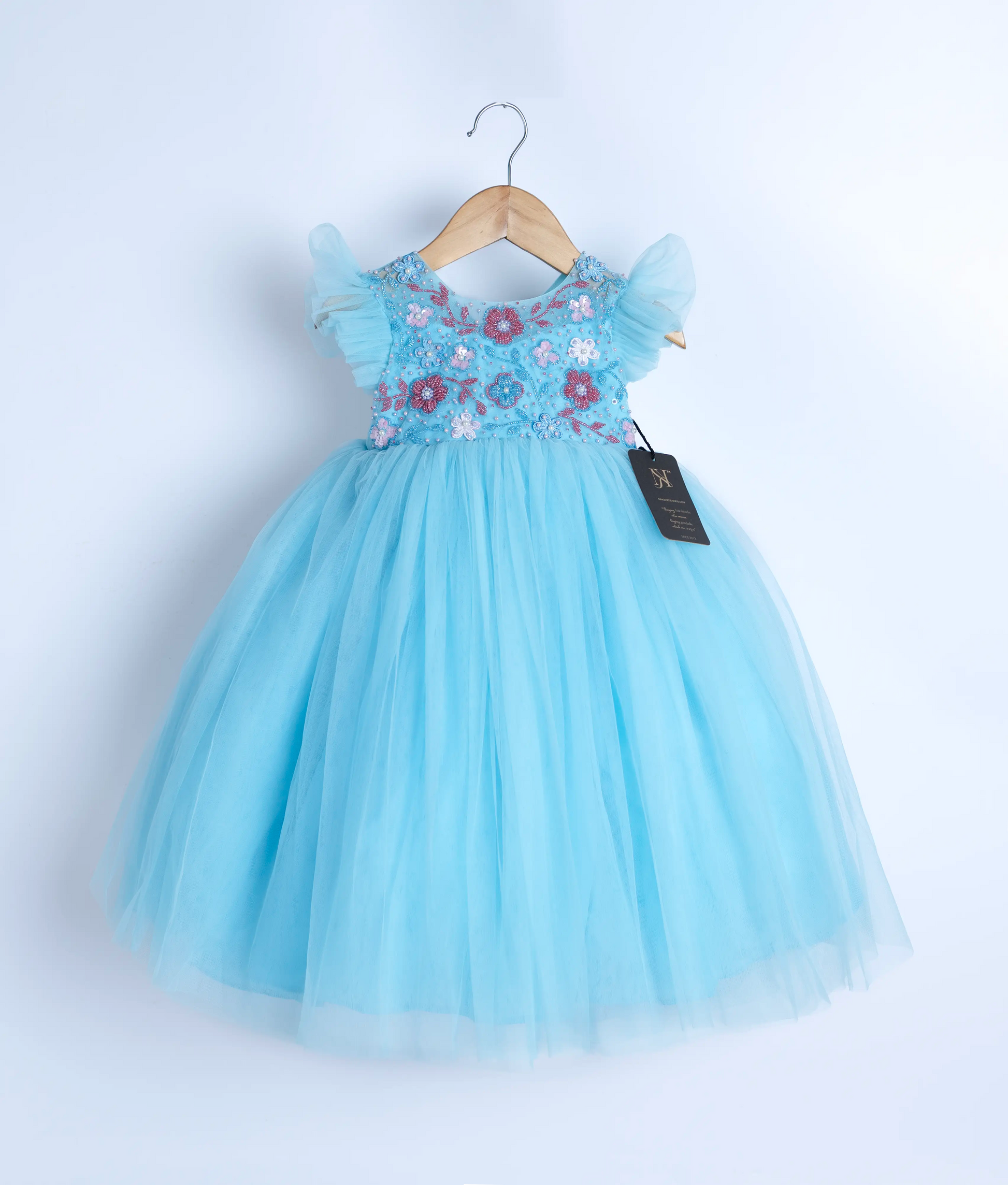 A blue tulle net frock displayed on a hanger.