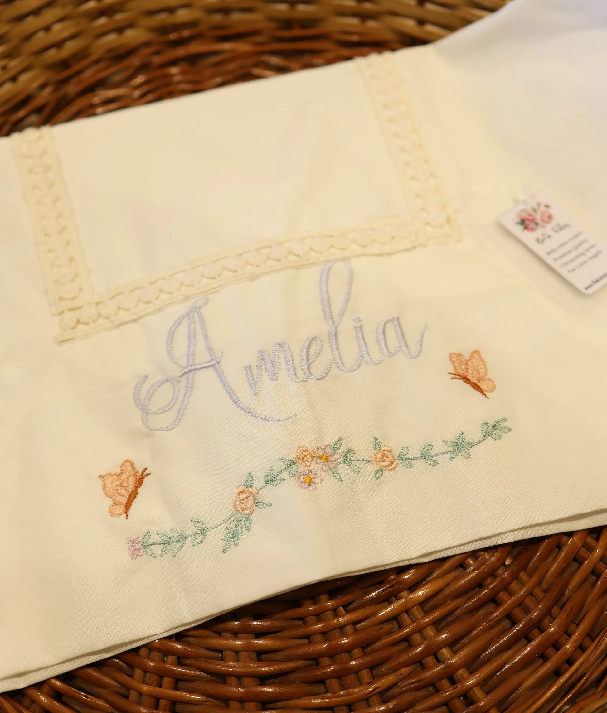 Close view of an off-white embroidery baptism towel with a customized name.