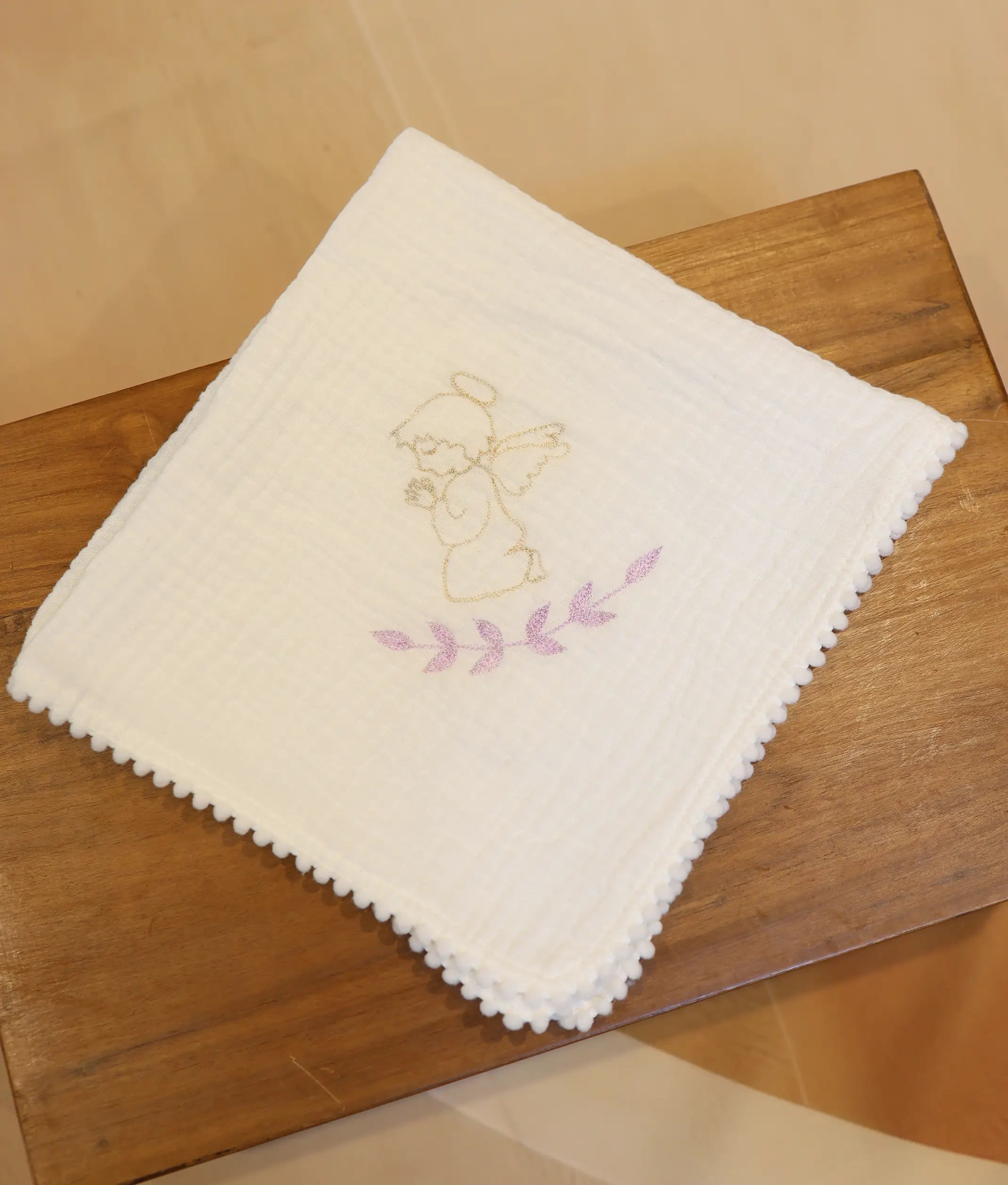 Front view of an off-white angel embroidery cotton baptism towel.