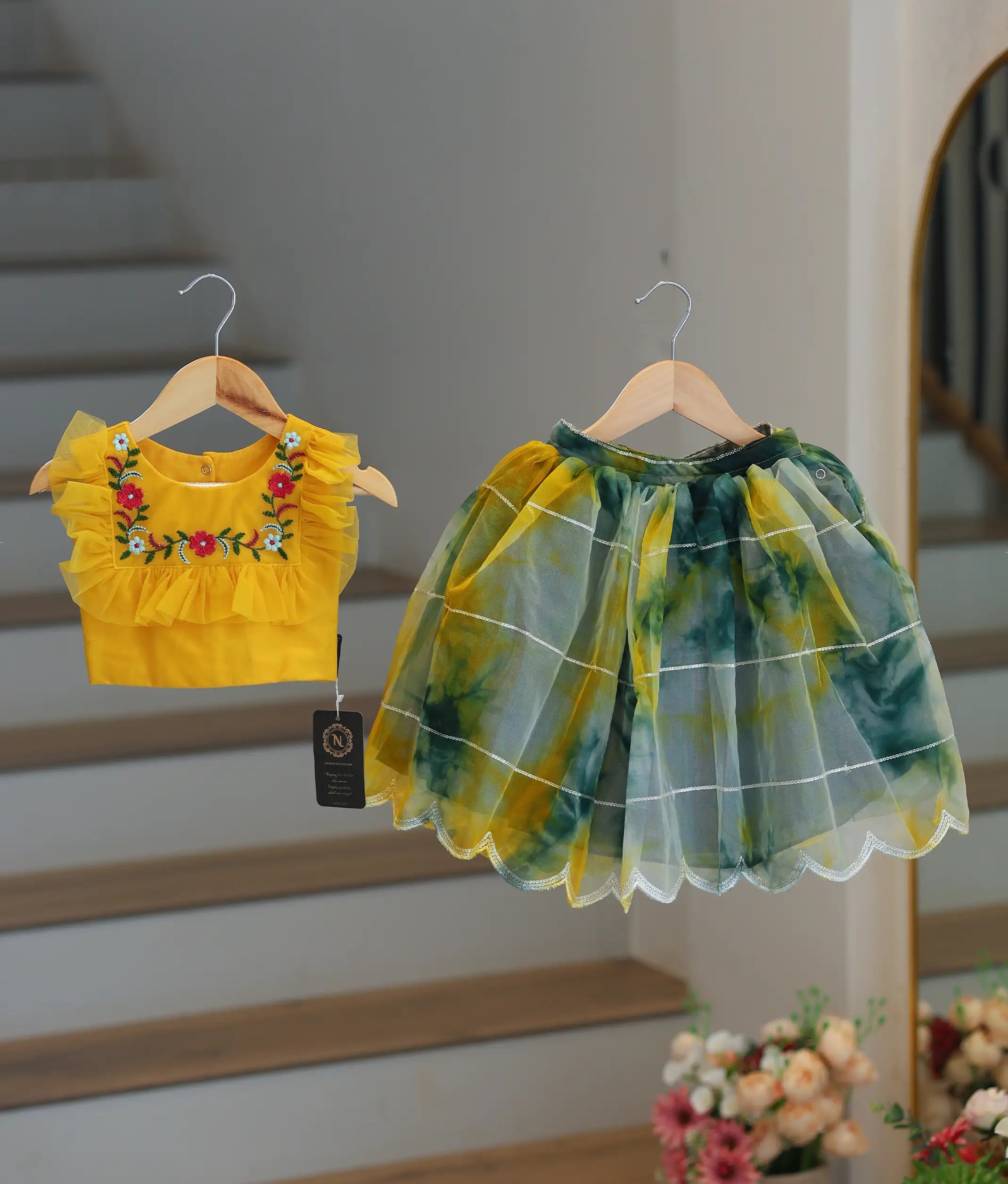 Front view of a yellow top with Green and yellow organza skirt.