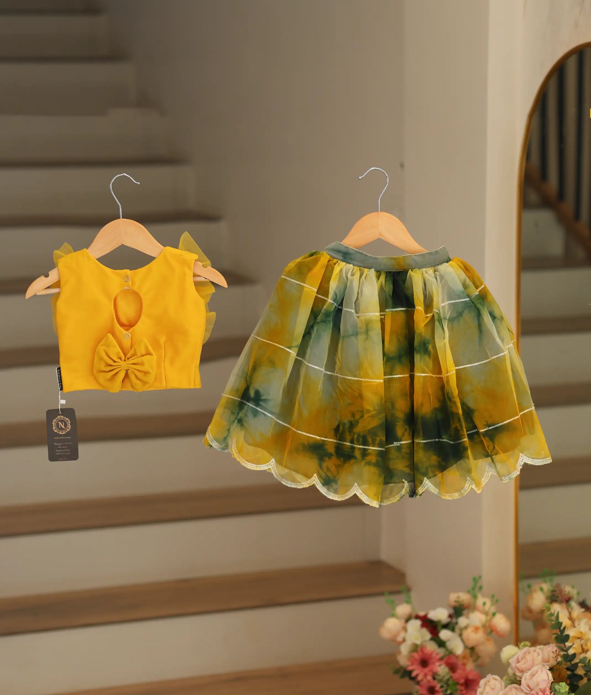 Back view of a yellow top with Green and yellow organza skirt.