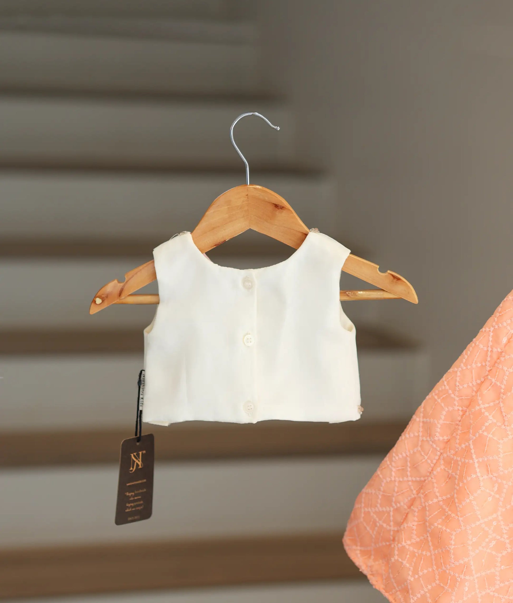 back viw of off white top