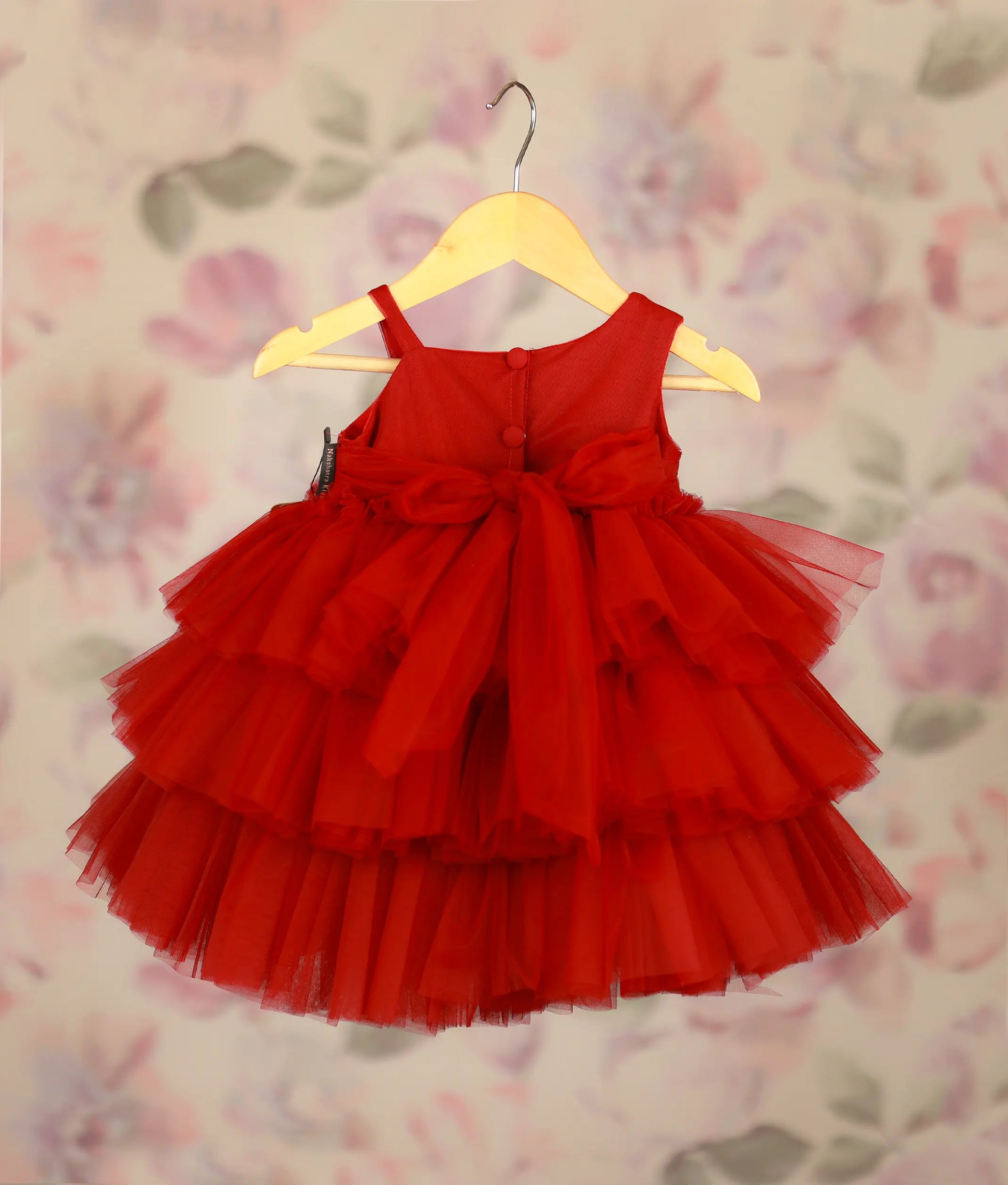 Back view of maroon tiered tulle baby frock with work material yoke and ruffled skirt for parties
