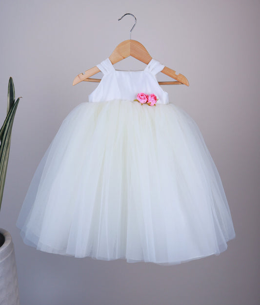 Front view of an of off-white tulle net birthday frock against white background.  