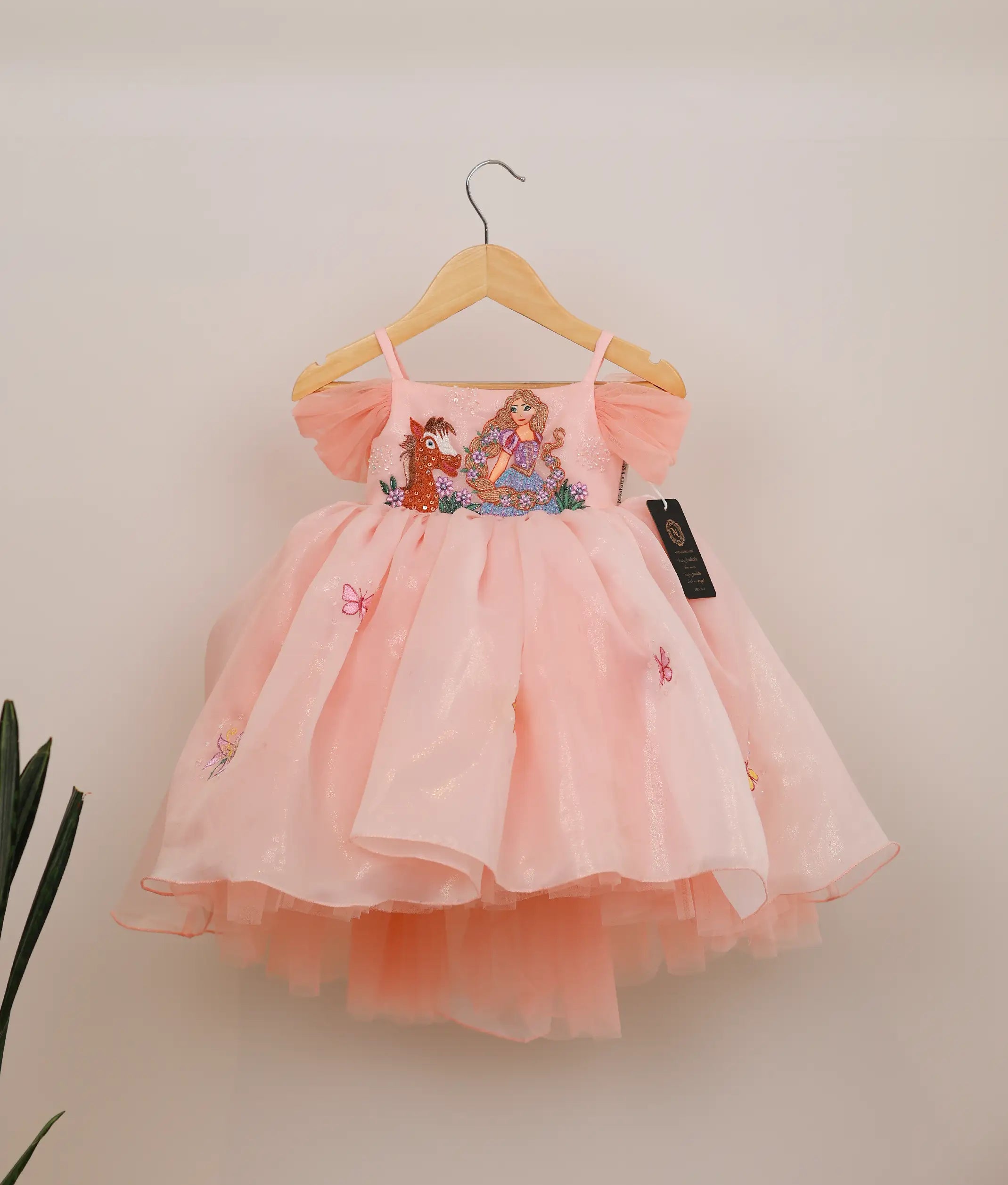 Front view of peach shimmer organza disney princess theme birthday frock