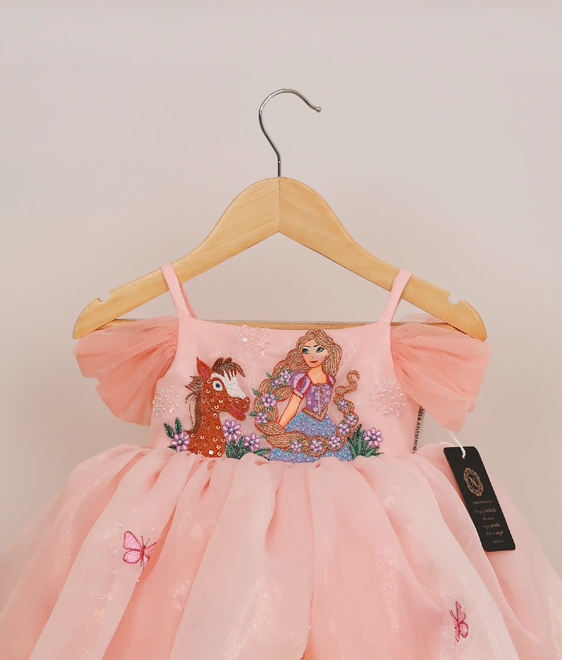 Close view of peach shimmer organza disney princess theme birthday frock