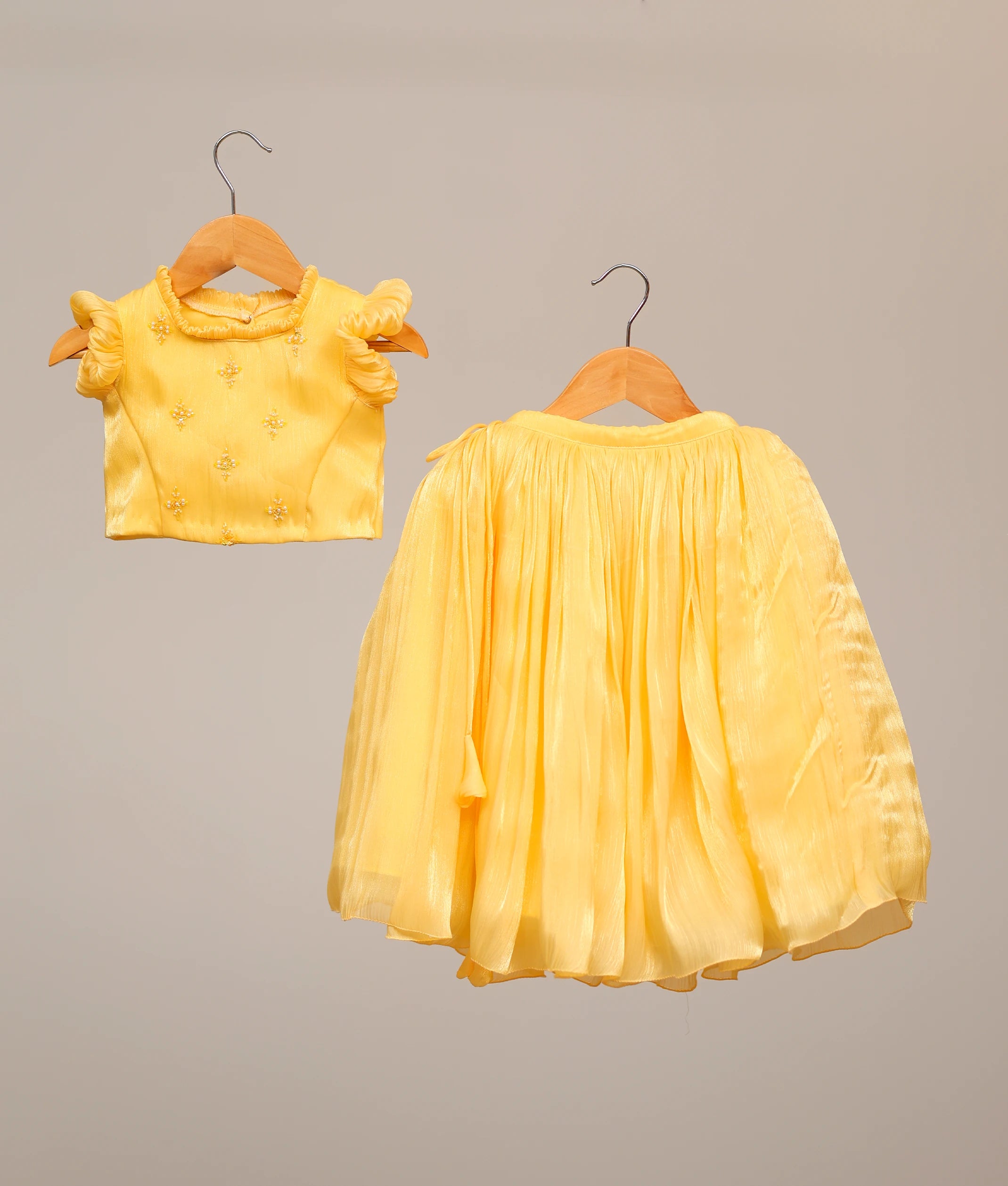 Front view of yellow lacer organza handworked skirt and top for baby girls with ruffle sleeves.